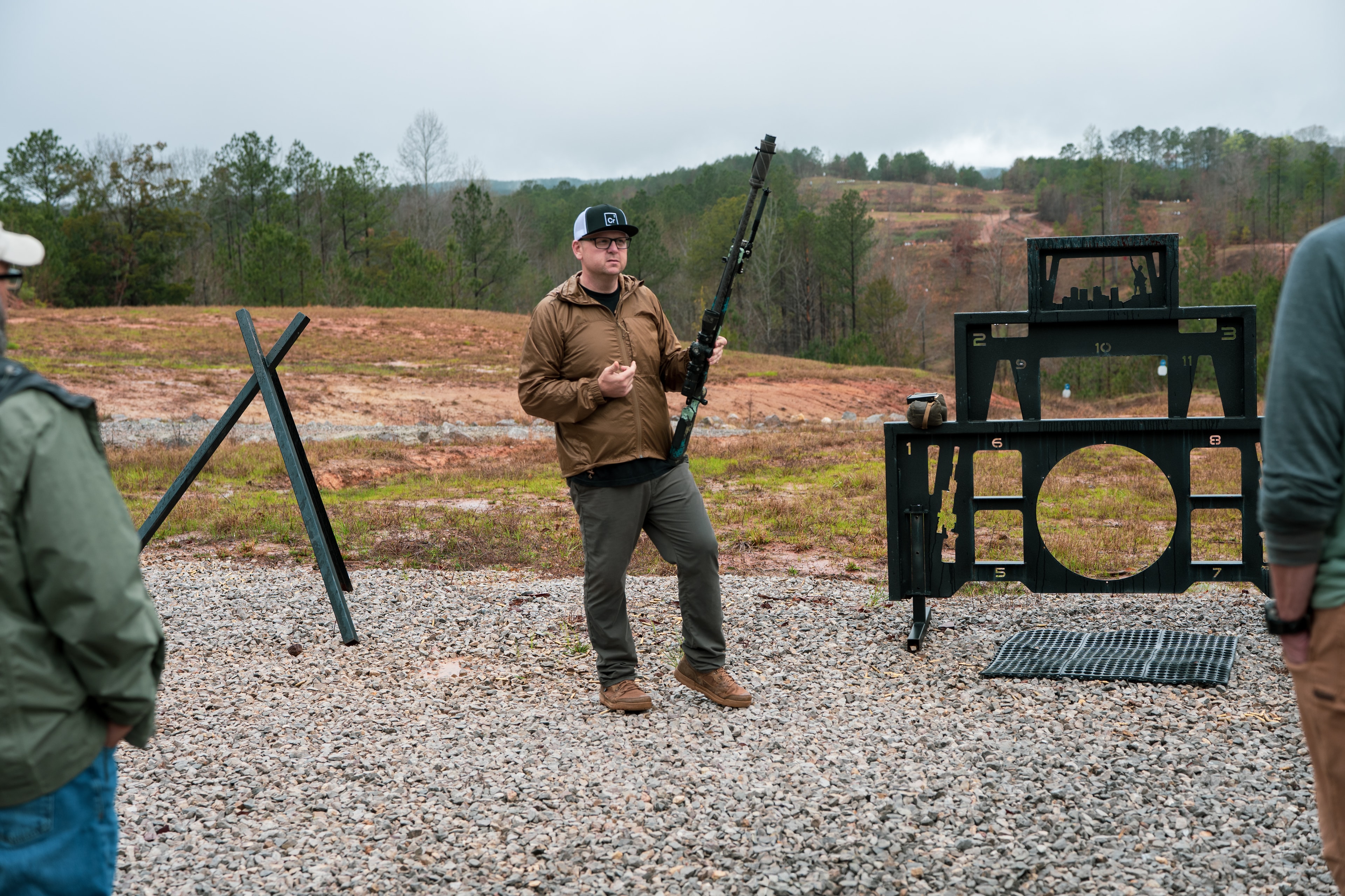 Chris Roberts instructing a shooter in front of a training barricade