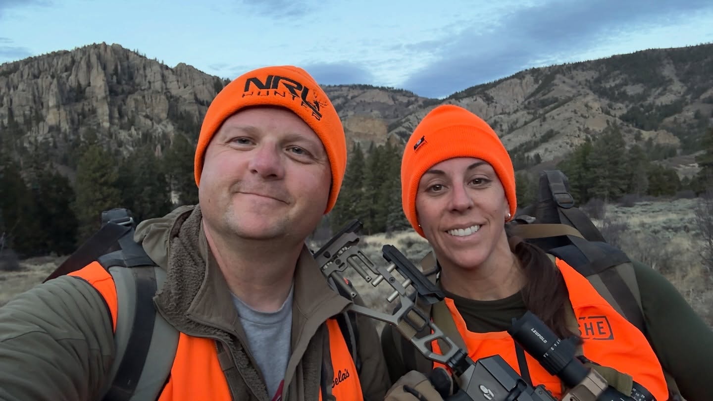 Two hunters together wearing orange hats, sharing the experience in the field